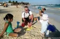 little kids play on the beach in playa del carmen