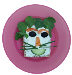 Kids can cook their own healthy an fun food, like this veggie face sandwich at a local amsterdam cafe