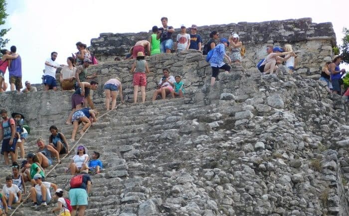 Tourists climb the ruined pyramid at coba, an activity best enjoyed with kids who can be responsible for their own safety.