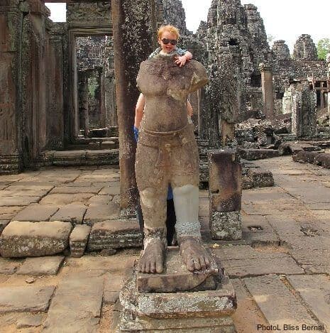 A toddler explores preah kahn temple at angkor.