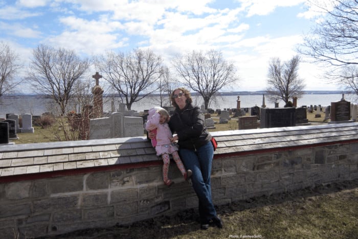 Mother and child in front of a scenic graveyard on ile d'orleans