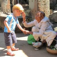 A toddler interacts with a Cambodian woman