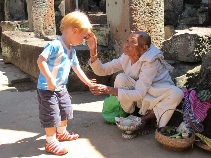 A toddler interacts with a Cambodian woman