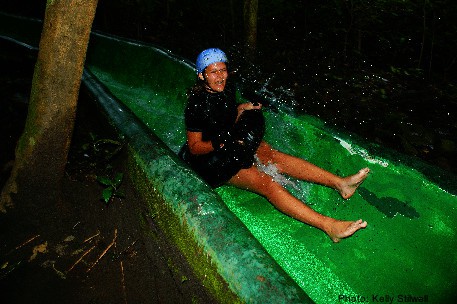 A girl wears a helmet going down a long, fast water slideat buena vista adventure center.