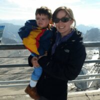 Mom and toddler enjoying a mountaintop view.