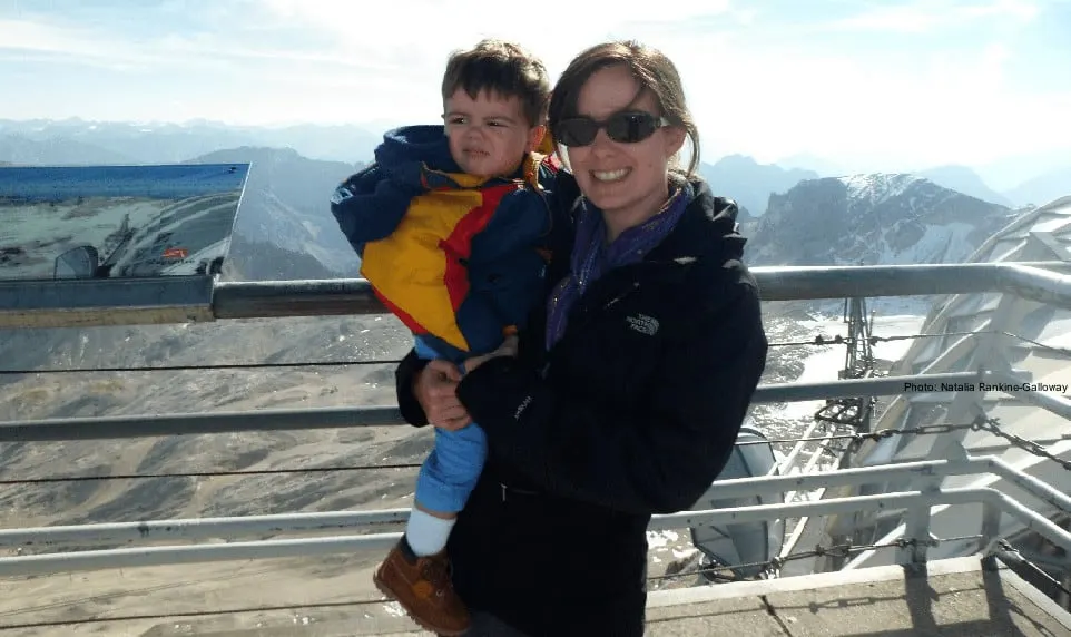 mom and toddler enjoying a mountaintop view.