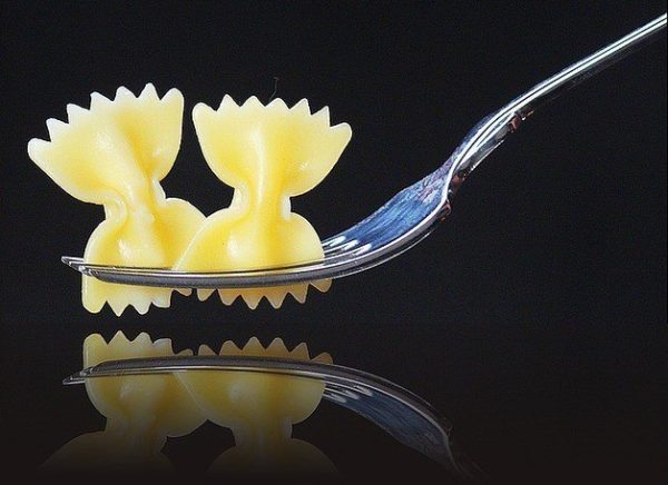 Bowties are the main ingredient in a pasta salad with a greek accent.