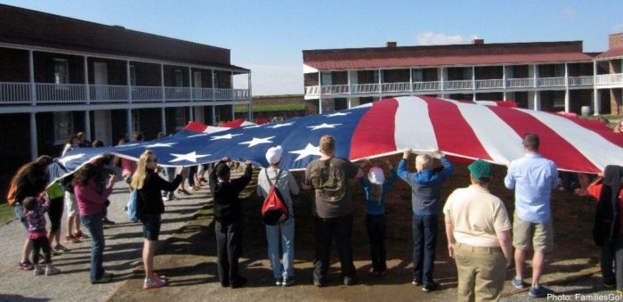 In a moment of hands-on history, visitors to fort mchenry in baltimore help raise the giants american flag that inspired the national anthem.