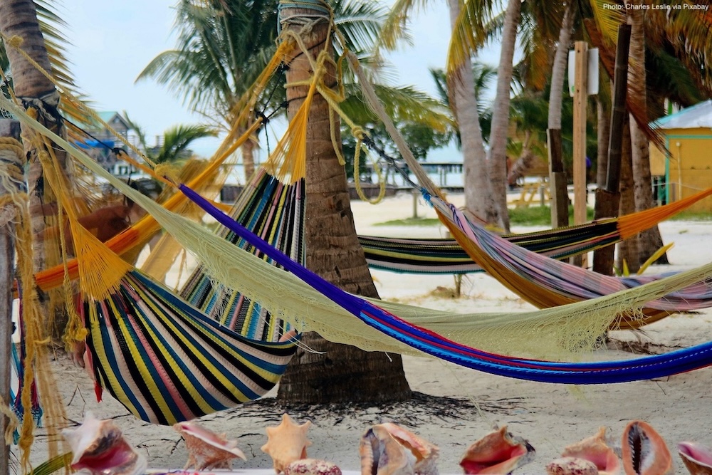 Hammocks strung along a beach in belize.