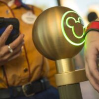 A Walt Disney World Resort guest uses a MagicBand to enter Magic Kingdom theme park in Lake Buena Vista, Fla. Guests also can use MagicBands to enter their Disney Resort hotel room, buy food and merchandise, enter Walt Disney World Resort theme parks and water parks, access their selected FastPass+ experiences and connect to Disney's PhotoPass. MagicBands are part of the new MyMagic+, which has the ability to connect nearly all aspects of the guest vacation experience at Walt Disney World Resort.