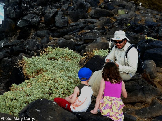 a guide talks to two young children on one of the galapagos islands