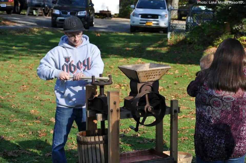 picking apples and then making them into cider  with an old-fashined press is a good fall activity when your leaf-peeping with kids