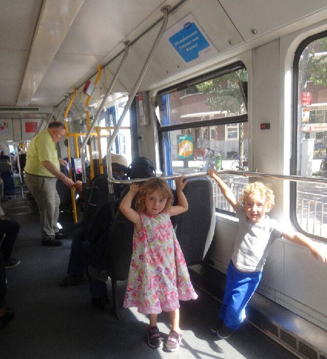 two kids on the gvb tram in amsterdam