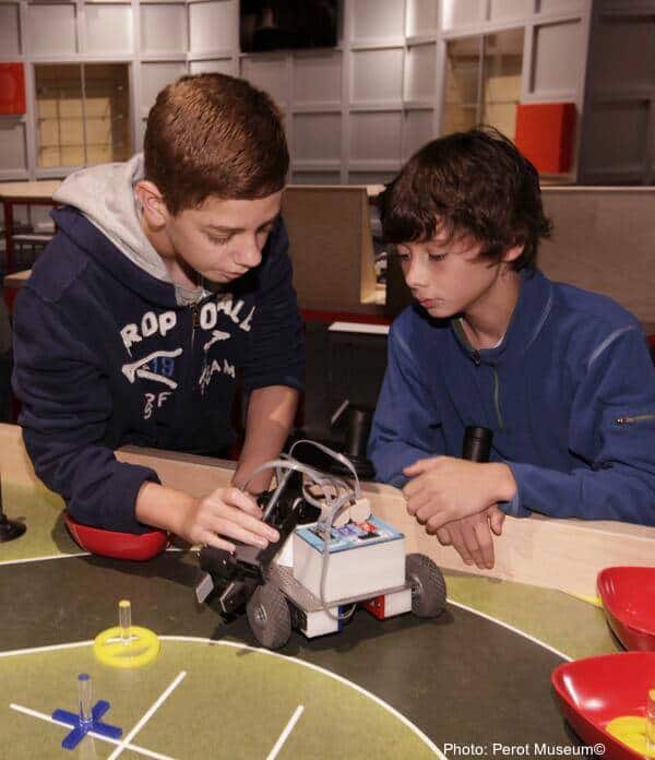 Kids building cars at the perot museum
