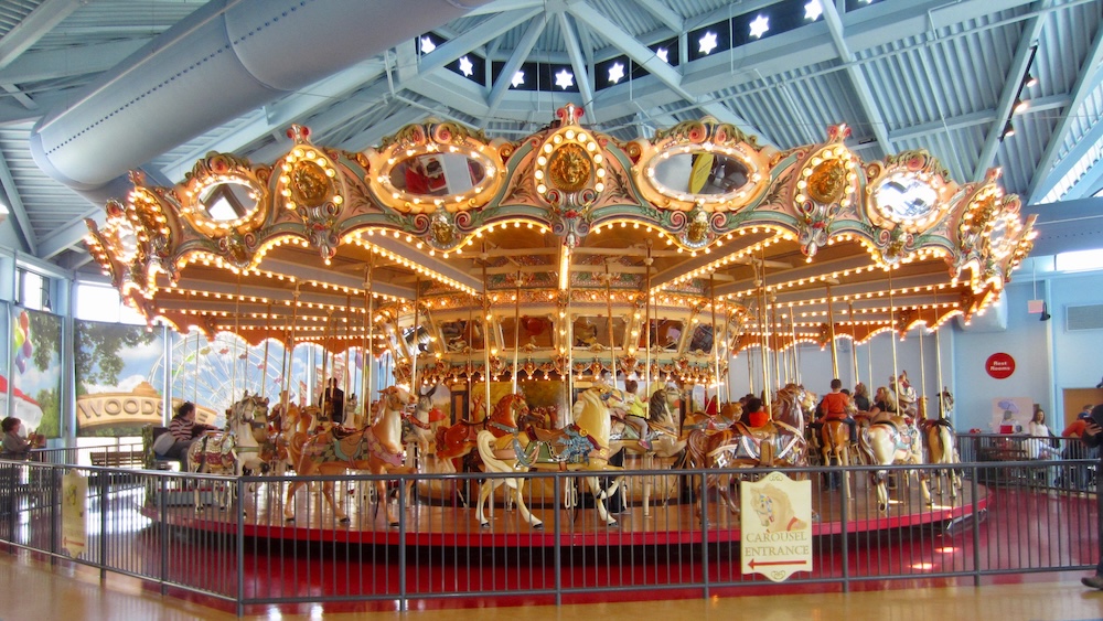 The please touch museum has an indoor carousel that is large and fast.