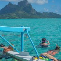 snorkeling in crystal clear blue water off of Bora Bora