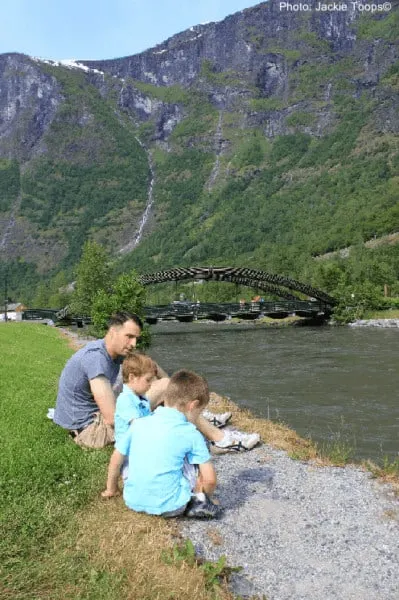 a family admiring the mountain view on a nature walk in the nordic countries. 