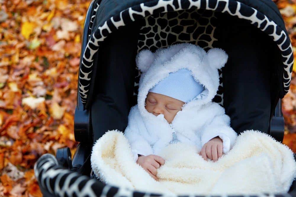 Child napping outside on a fall day