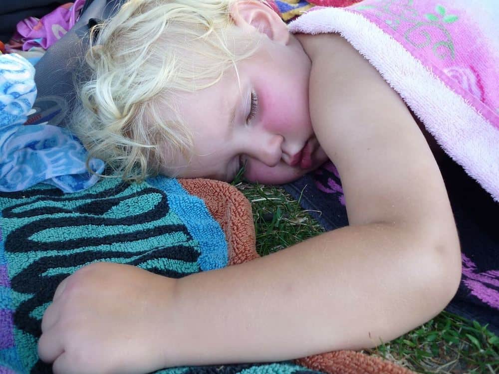 Child napping on a lawn