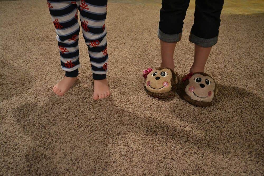 Kids in pajamas and funny slippers, a nice way to spend your staycation.