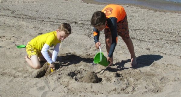 Kids play on a lake michigan beach.