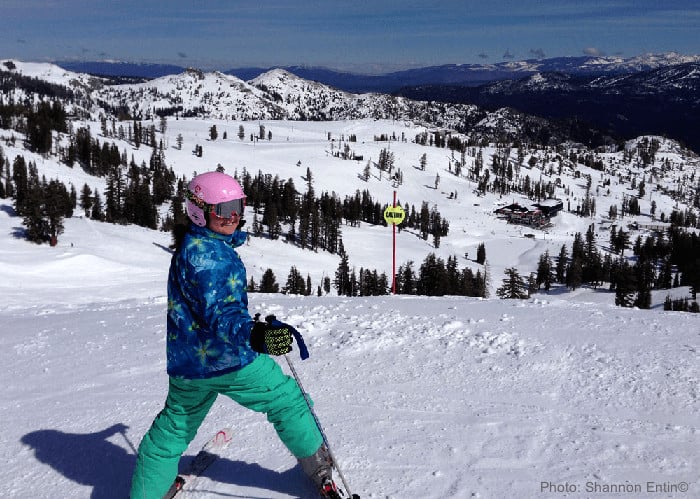 ski trips with kids build self confidence. this twee girl is ready to head downhill.