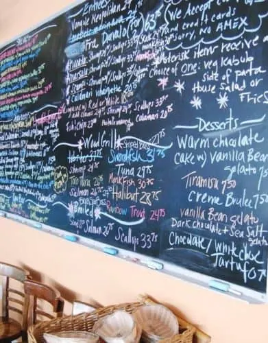 the daily menu and specials on the chalkboard at scales & shells