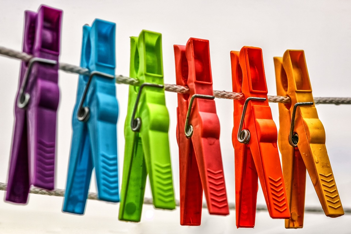 Colorful clothes pins on a clothesline.
