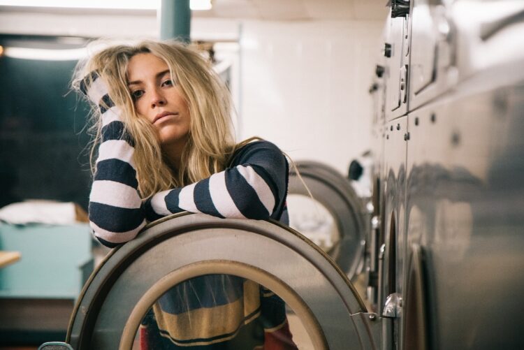 woman bored laundromat