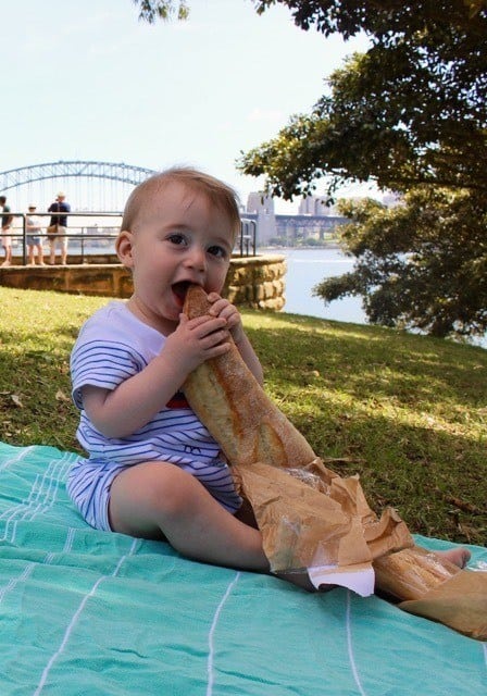A long haul flight is worth it when you arrive and you're watching your tot nibble on a baguette with the harbor bridge behind you.