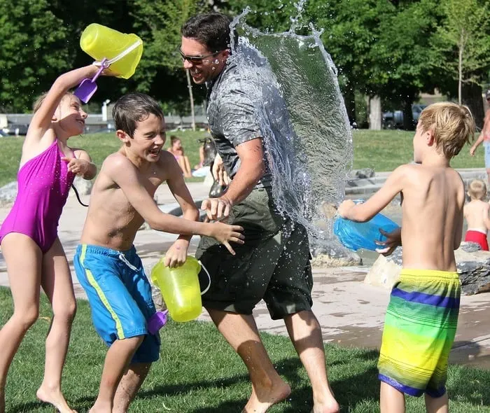 a water fight in your yard is a fun and easy staycation activity with kids.