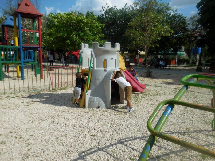 A toddler takes a playground break from sightseeing in havana