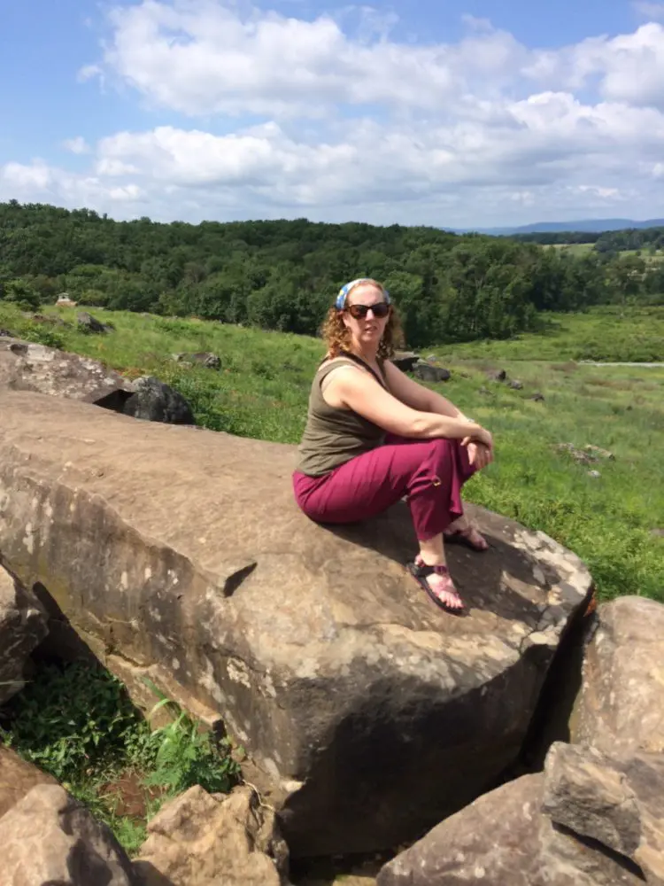 the writer on a rock on the union side of the gettysburg battlefield.