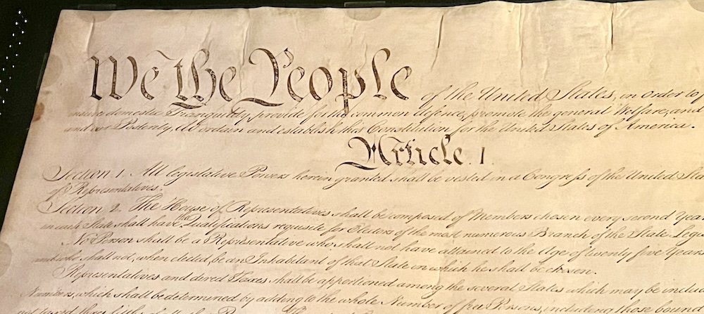 The first paragraphs of the constitution with we the people" in large script on its original parchment