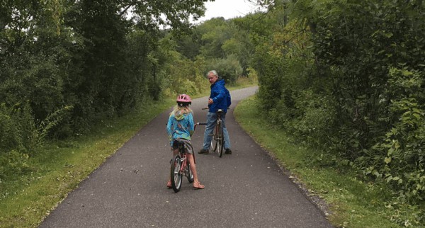 A dad and daughter pause in the bicyle ride on the  ashuwillticook rail trail in the berkshires