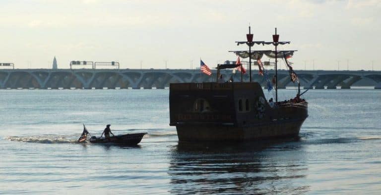Urban pirates plunder national harbor, tailed by a pirate in an outboard skiff.