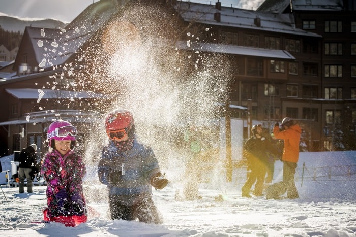 Kids play in the snow at winter park