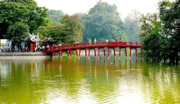 huc bridge is lovely. the red bridge spans small lake.