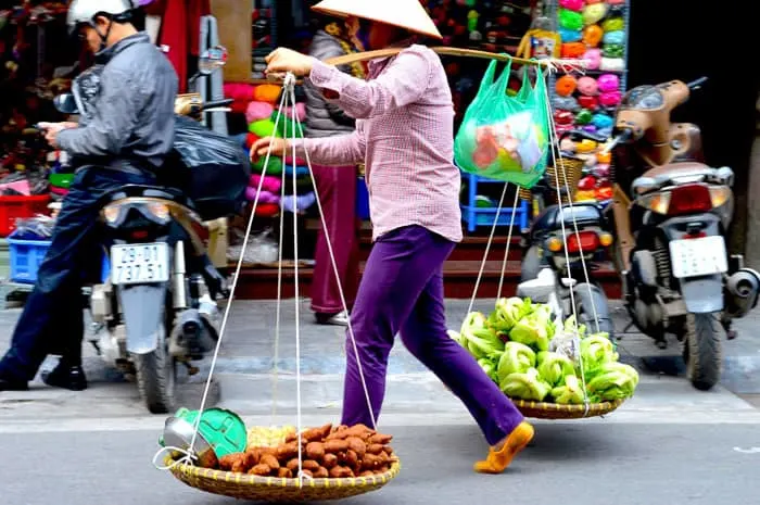 a peddler with her wares in hanoi