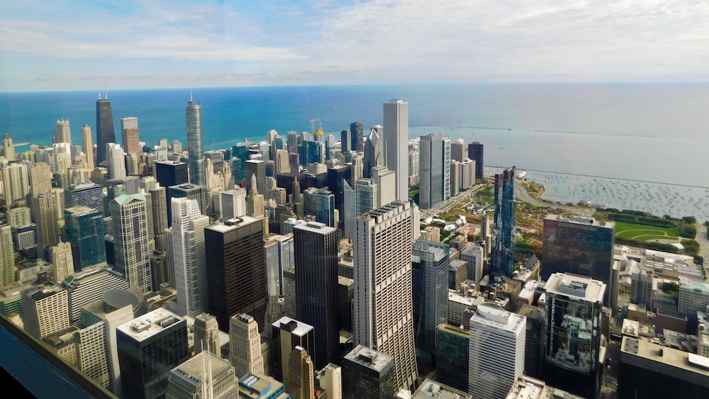 View of lake michigan and skyscrapers from atop chicago's willis tower.