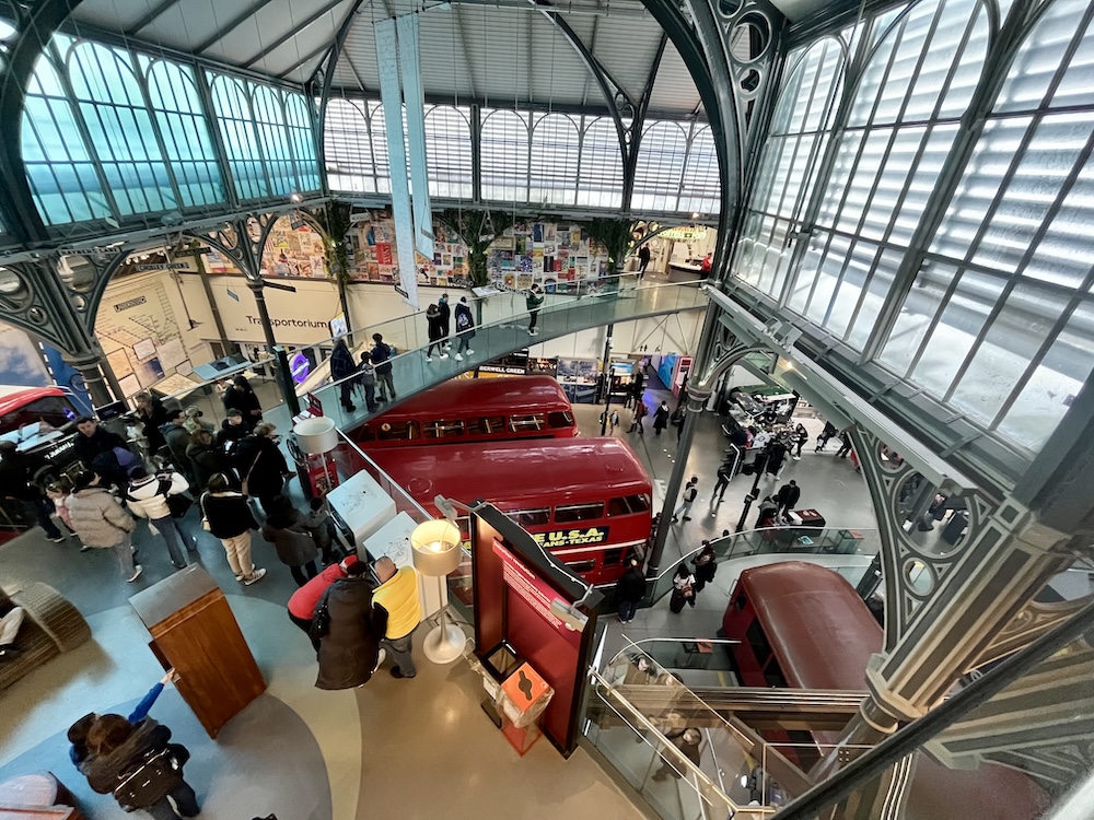The london transport museum is a bright, open-architecture space with several levels of buses, trains and transportation history