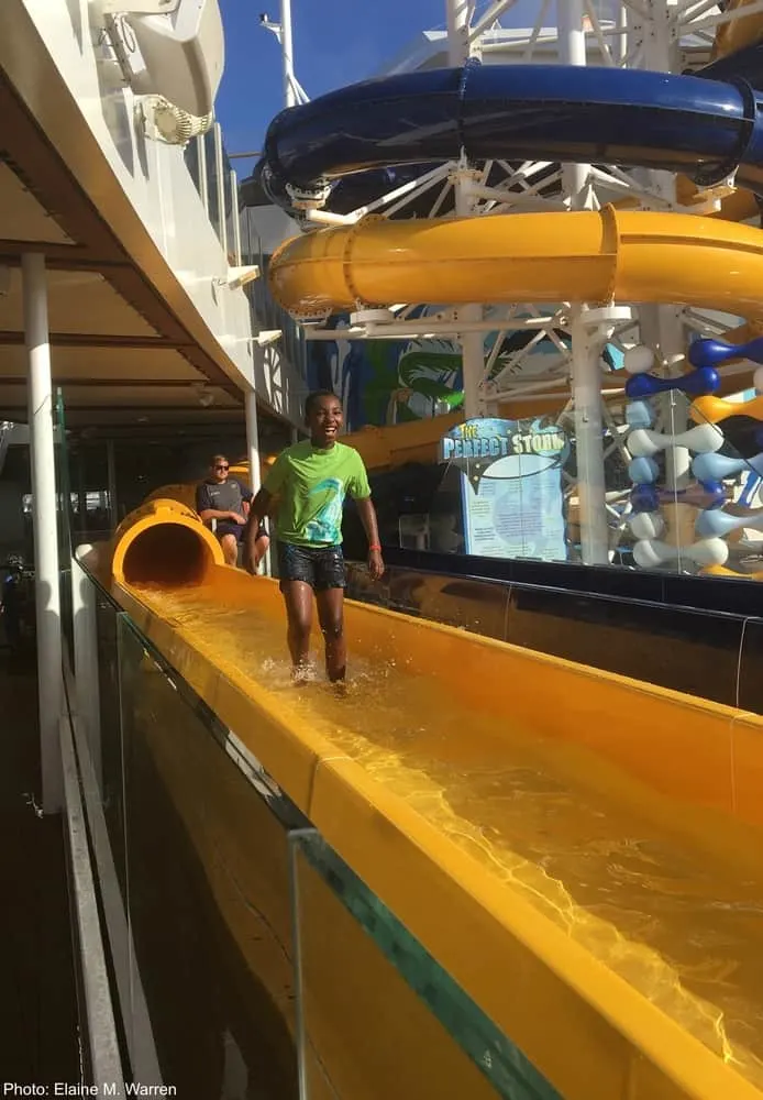 kids love royal caribbean's water slides. this child emerges from a twisting slide. 