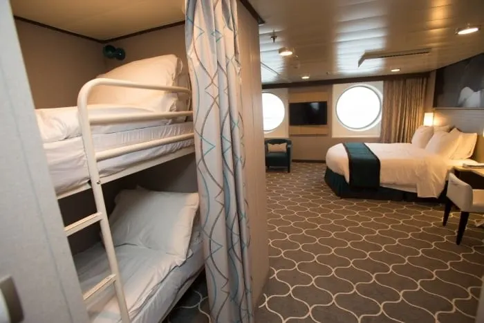 rroyal caribbean has larger family cabins for those who need more room. this one has bunk beds with privacy curtains.