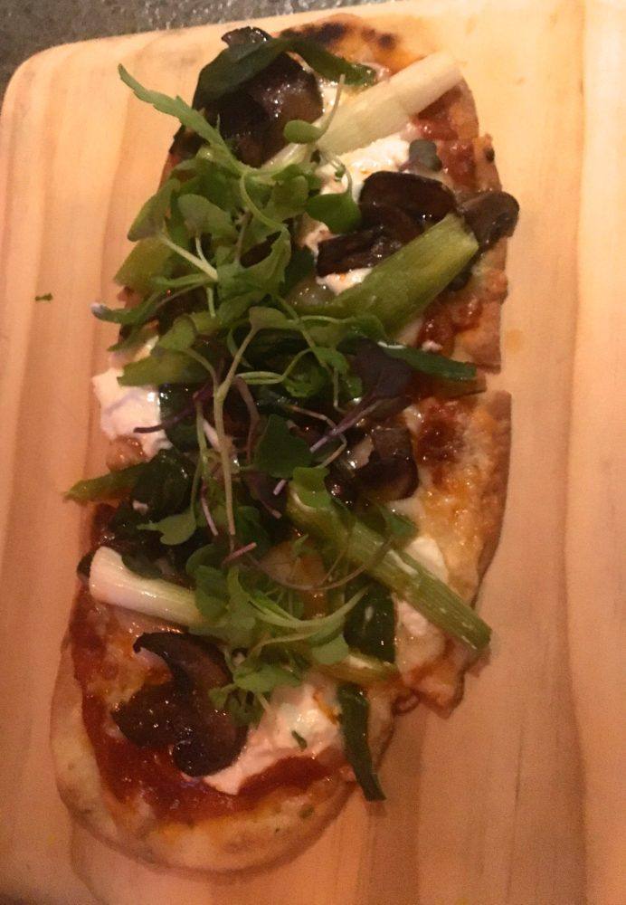 Flatbread with goat cheese, mushrooms and green on top at nektar, a popular restaurant in new hope, pa