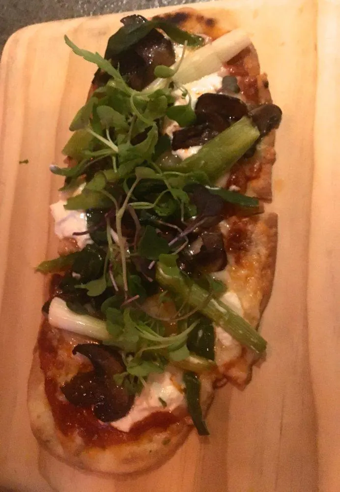 flatbread with goat cheese, mushrooms and green on top at nektar, a popular restaurant in new hope, pa