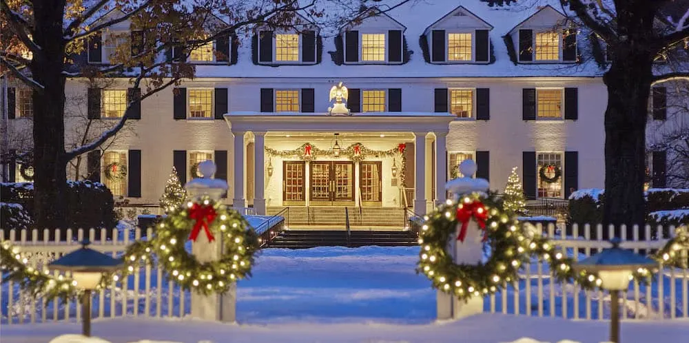 the woodstock inn in vermont offers guests a new england christmas with lots of locally cut trees, evergreen swags and lights.