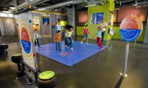 kids jump on a sound board at a science museum. many childrens museums offer reciprocity for members of sister museums, a handy vacation money-saver