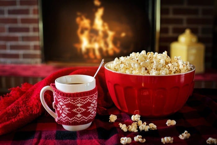 staycations can be fun if you treat yourself well, for example curling up by a roaring fire with fresh popcorn and hot cocoa.