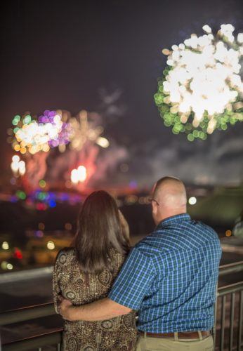 A couple watches fireworks for the california grill at the contemporary hotel
