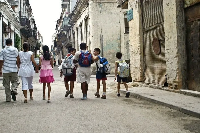 Ask Familiesgo!: How Can We Visit Cuba With Kids? Kids, teens and parents explore a cuba city street.